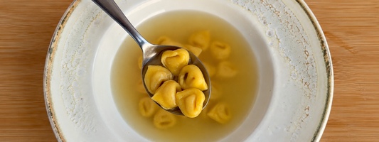 Discover the authentic tortellini in brodo recipe from Bologna and Modena. Learn how Italians prepare handmade pasta, traditional meat filling and golden broth.
